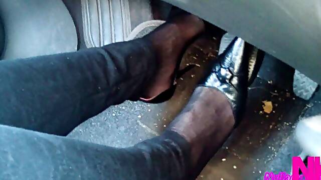 Driving and revving in black buckled pumps and jeans